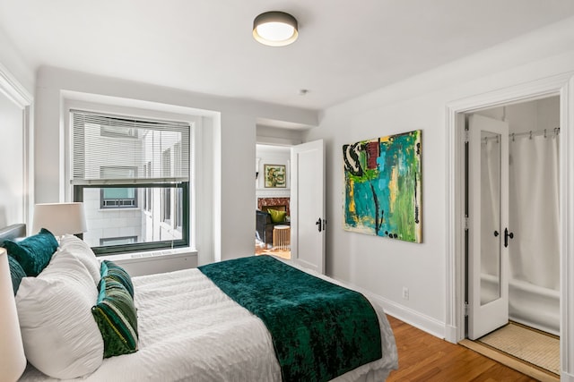 bedroom featuring baseboards and wood finished floors