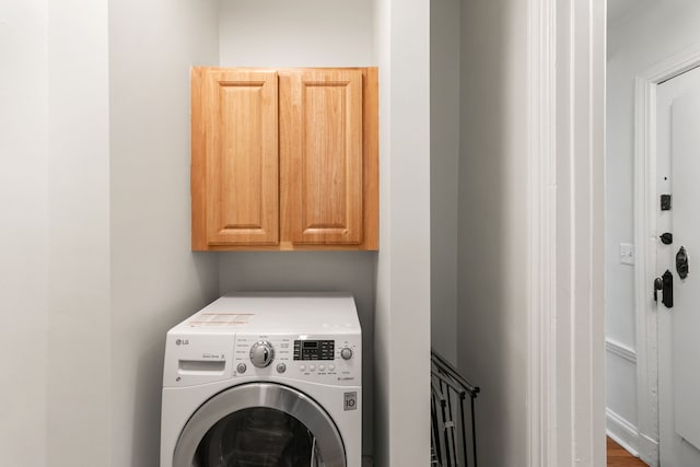 washroom with washer / dryer and cabinet space