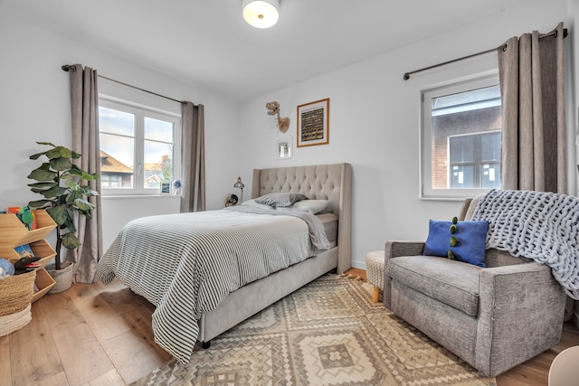 bedroom with baseboards and wood finished floors