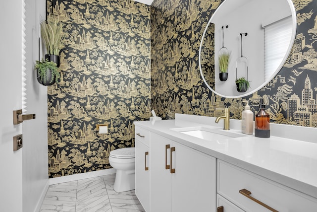 bathroom featuring marble finish floor, vanity, toilet, and wallpapered walls