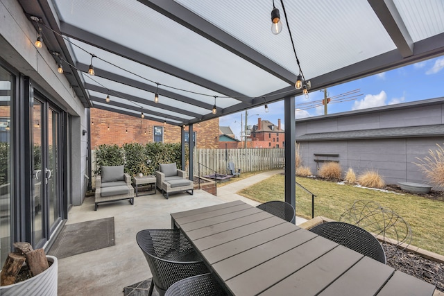 view of patio featuring fence and outdoor dining space