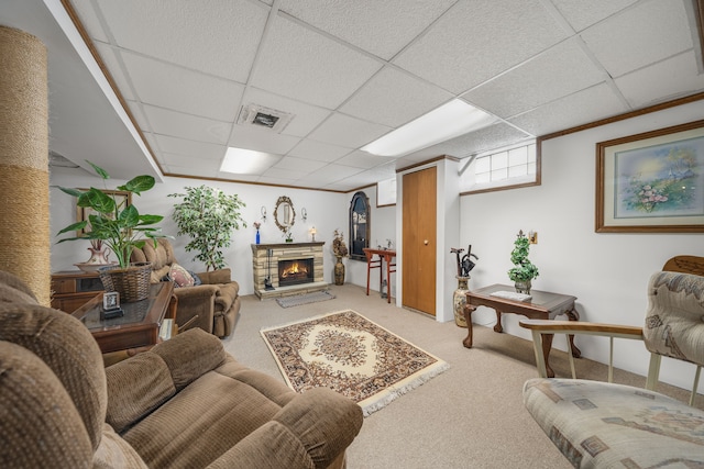 living room featuring a paneled ceiling, visible vents, light colored carpet, and a stone fireplace