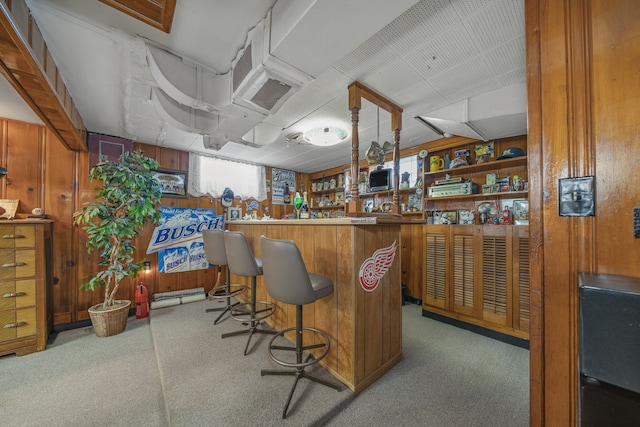 bar featuring a dry bar, wooden walls, carpet floors, and stainless steel microwave