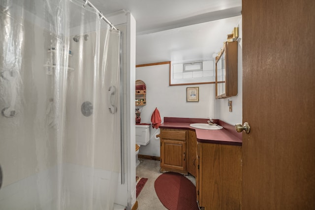 bathroom with toilet, vanity, and a shower with curtain