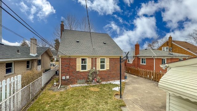 rear view of property with a patio area, a fenced backyard, brick siding, and a lawn