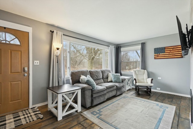 living area with dark wood-type flooring and baseboards