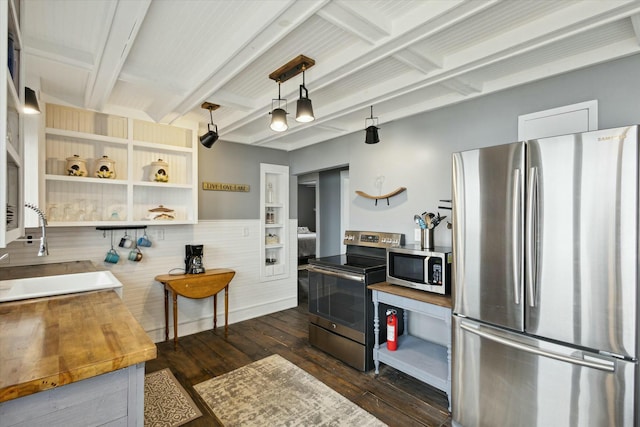 kitchen featuring a sink, appliances with stainless steel finishes, open shelves, beamed ceiling, and dark wood finished floors