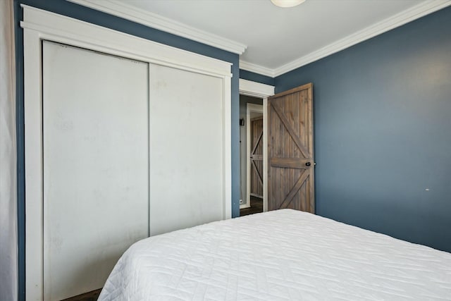 bedroom featuring ornamental molding and a closet