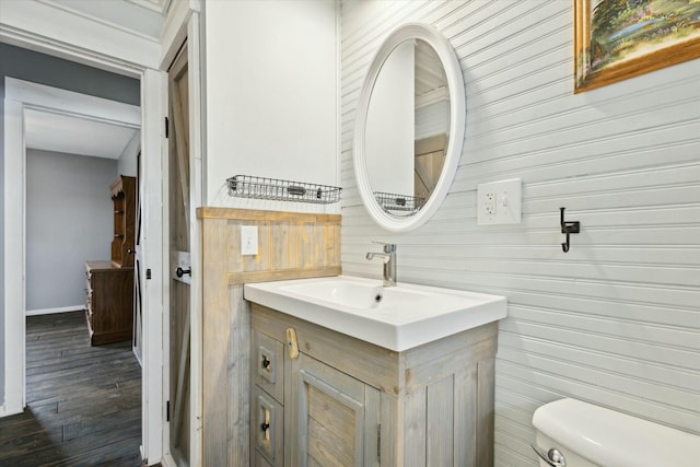 bathroom with vanity, wood finished floors, and toilet