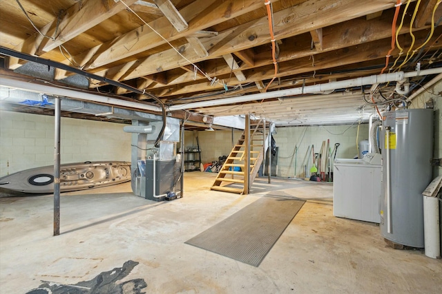 unfinished below grade area featuring heating unit, washing machine and dryer, stairs, and gas water heater