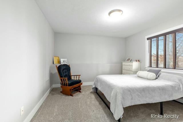 bedroom with carpet floors and baseboards