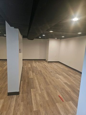 finished basement featuring light wood-style flooring and recessed lighting