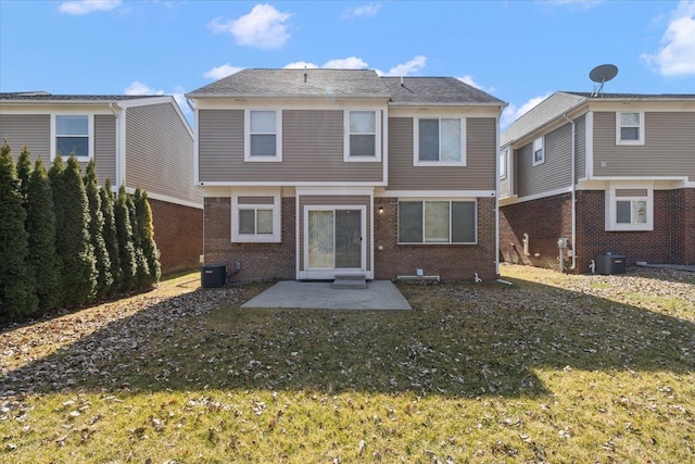 back of house with cooling unit, a patio, a lawn, and brick siding