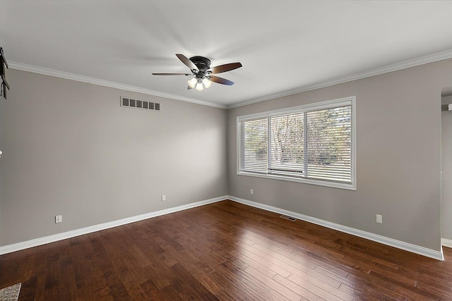 spare room featuring dark wood-style floors, visible vents, and baseboards