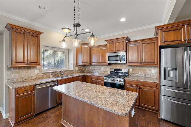 kitchen featuring a sink, stainless steel appliances, ornamental molding, and brown cabinetry