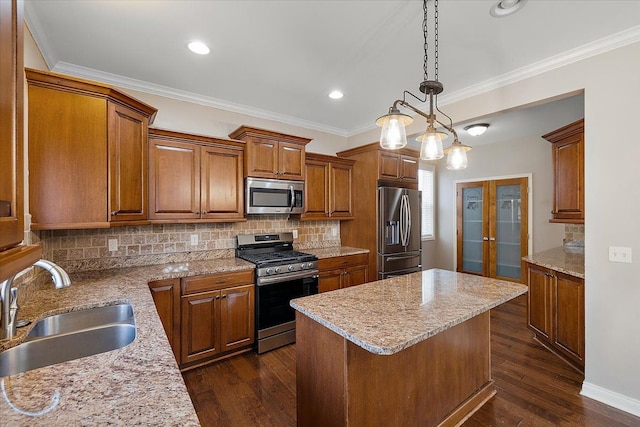 kitchen featuring brown cabinets, french doors, dark wood-style floors, stainless steel appliances, and a sink