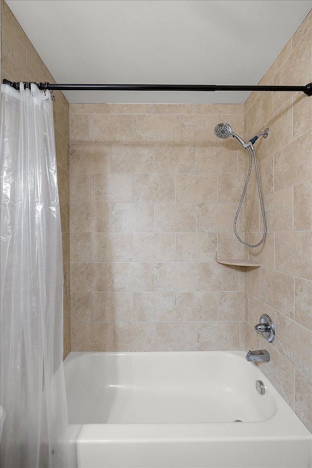 bathroom with shower / bathtub combination with curtain