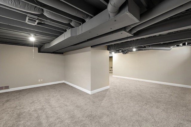 finished basement with visible vents, carpet, and baseboards