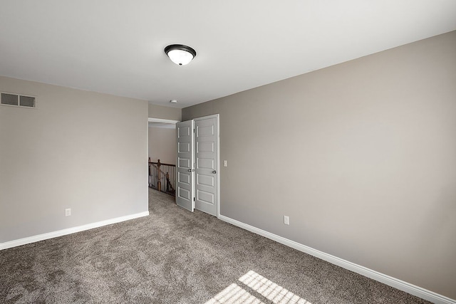 unfurnished bedroom with visible vents, carpet flooring, and baseboards