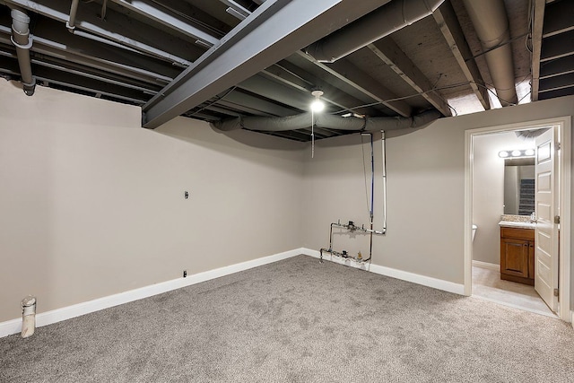 finished basement featuring carpet flooring and baseboards