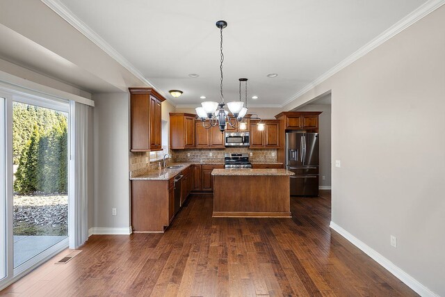 kitchen featuring a sink, backsplash, appliances with stainless steel finishes, and dark wood-style floors