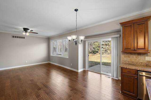 unfurnished dining area with visible vents, plenty of natural light, dark wood-style flooring, and crown molding