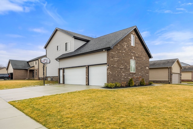 view of side of home featuring a garage, a yard, brick siding, and concrete driveway