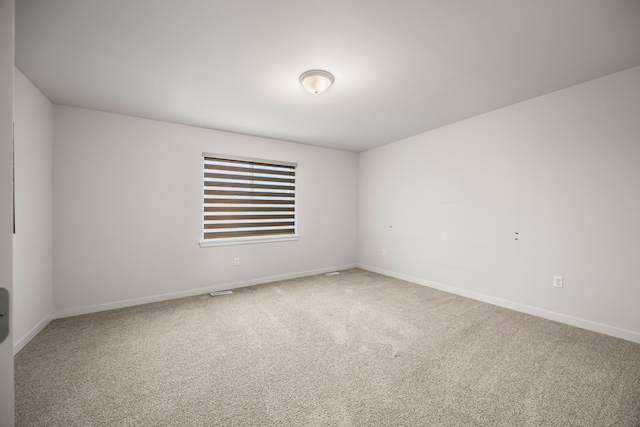 unfurnished room with baseboards and carpet flooring