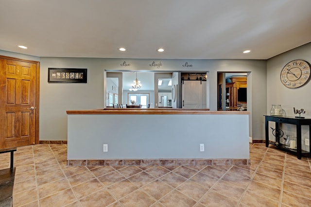 kitchen with light tile patterned floors, baseboards, and recessed lighting