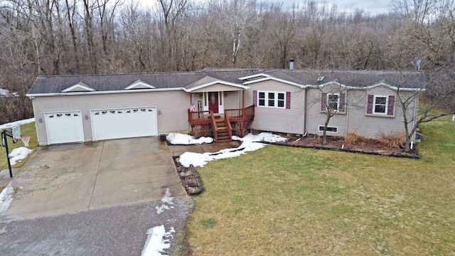 single story home with a garage, a front yard, and driveway