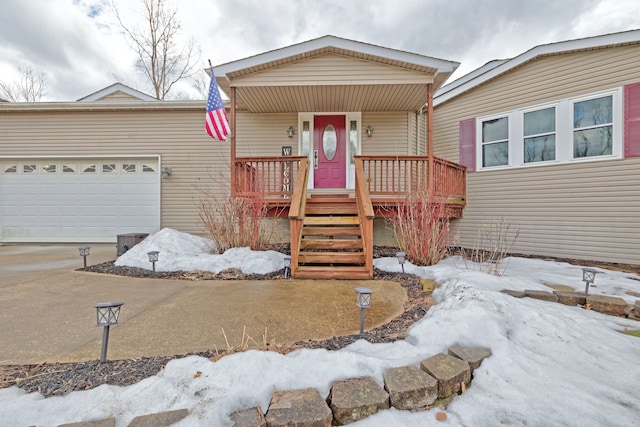 view of front of home with a garage and a porch