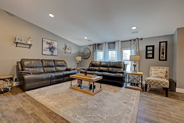 living area featuring recessed lighting, wood finished floors, visible vents, baseboards, and vaulted ceiling