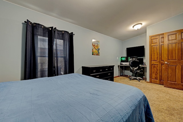 bedroom featuring carpet floors and lofted ceiling