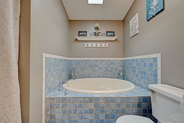 full bathroom featuring toilet and a garden tub