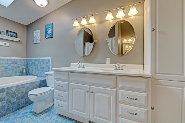 bathroom featuring double vanity, toilet, tile patterned flooring, tiled tub, and a sink