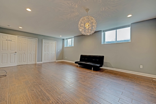 unfurnished room featuring baseboards, wood finished floors, and recessed lighting