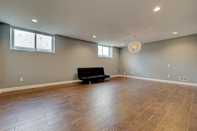 unfurnished room with baseboards, visible vents, dark wood-style flooring, and recessed lighting