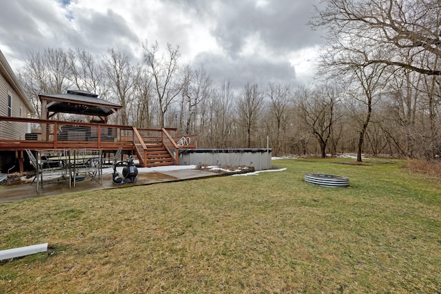 view of yard featuring a covered pool, a patio, and a deck