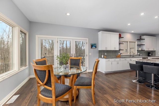 dining area featuring dark wood-style floors, visible vents, and plenty of natural light