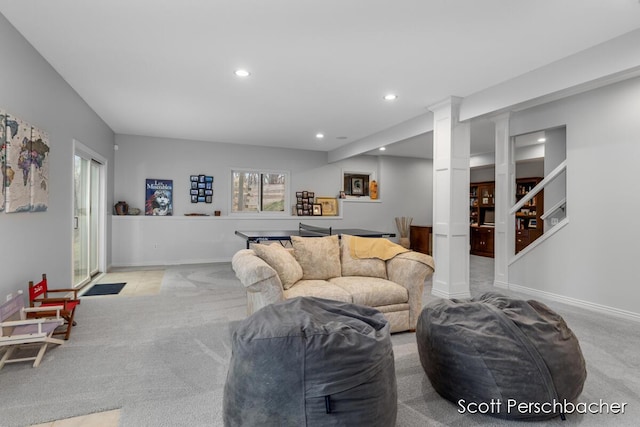 carpeted living room with ornate columns, baseboards, and recessed lighting