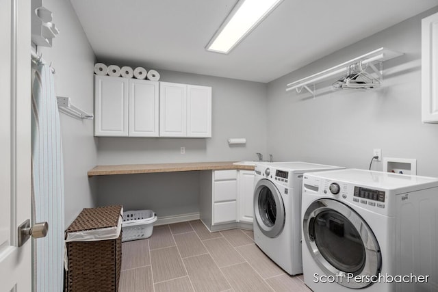 laundry area featuring a sink, cabinet space, and washer and dryer