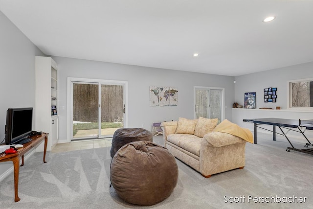 carpeted living room featuring built in features and recessed lighting