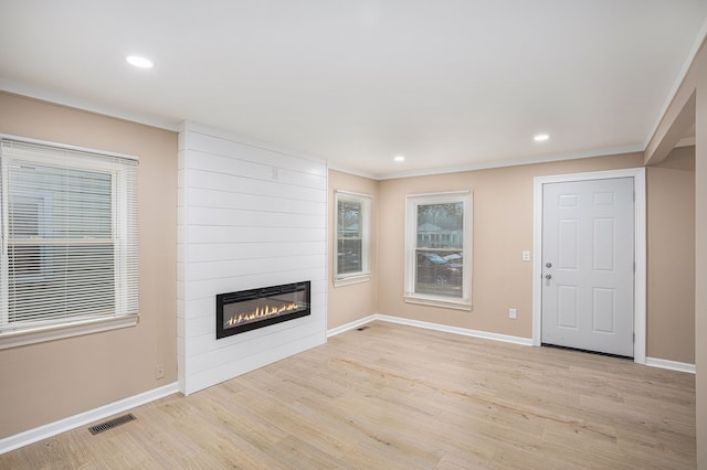 unfurnished living room featuring recessed lighting, a large fireplace, visible vents, baseboards, and light wood-type flooring