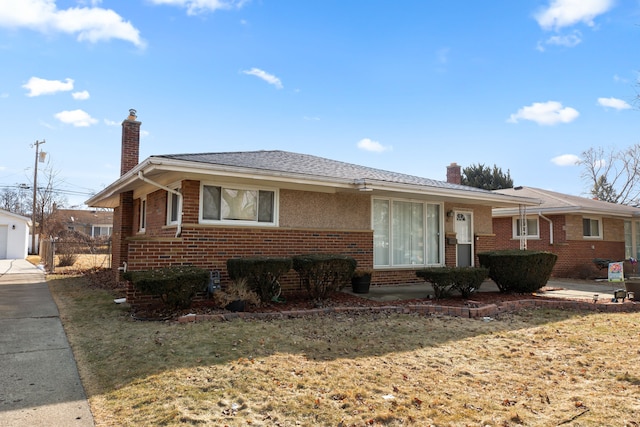 view of front of property with a chimney, fence, and brick siding