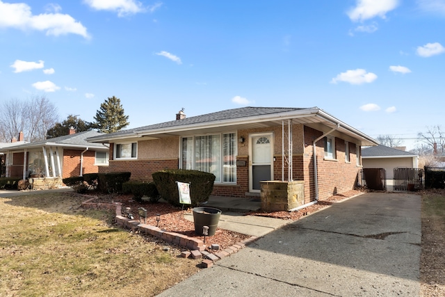 ranch-style home with brick siding, a front lawn, and a chimney