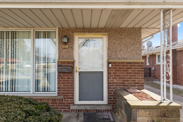 property entrance featuring brick siding