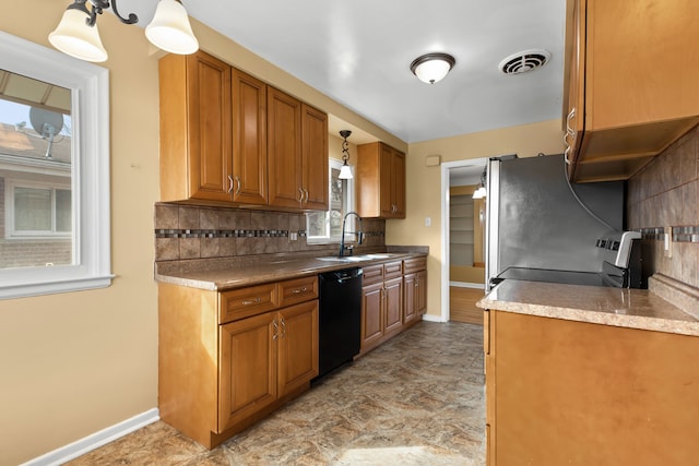 kitchen featuring visible vents, brown cabinets, a sink, stainless steel appliances, and backsplash