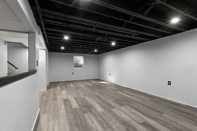 finished basement featuring wood finished floors