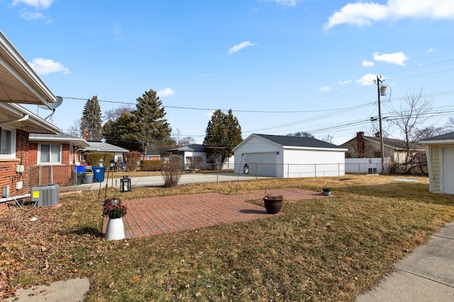 view of yard featuring cooling unit, fence, and an outbuilding