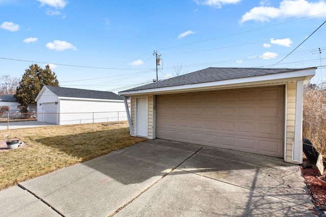 detached garage featuring fence